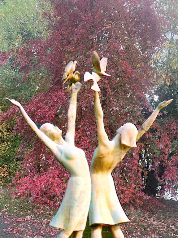 Be the Change: women dancing with doves, fall colors